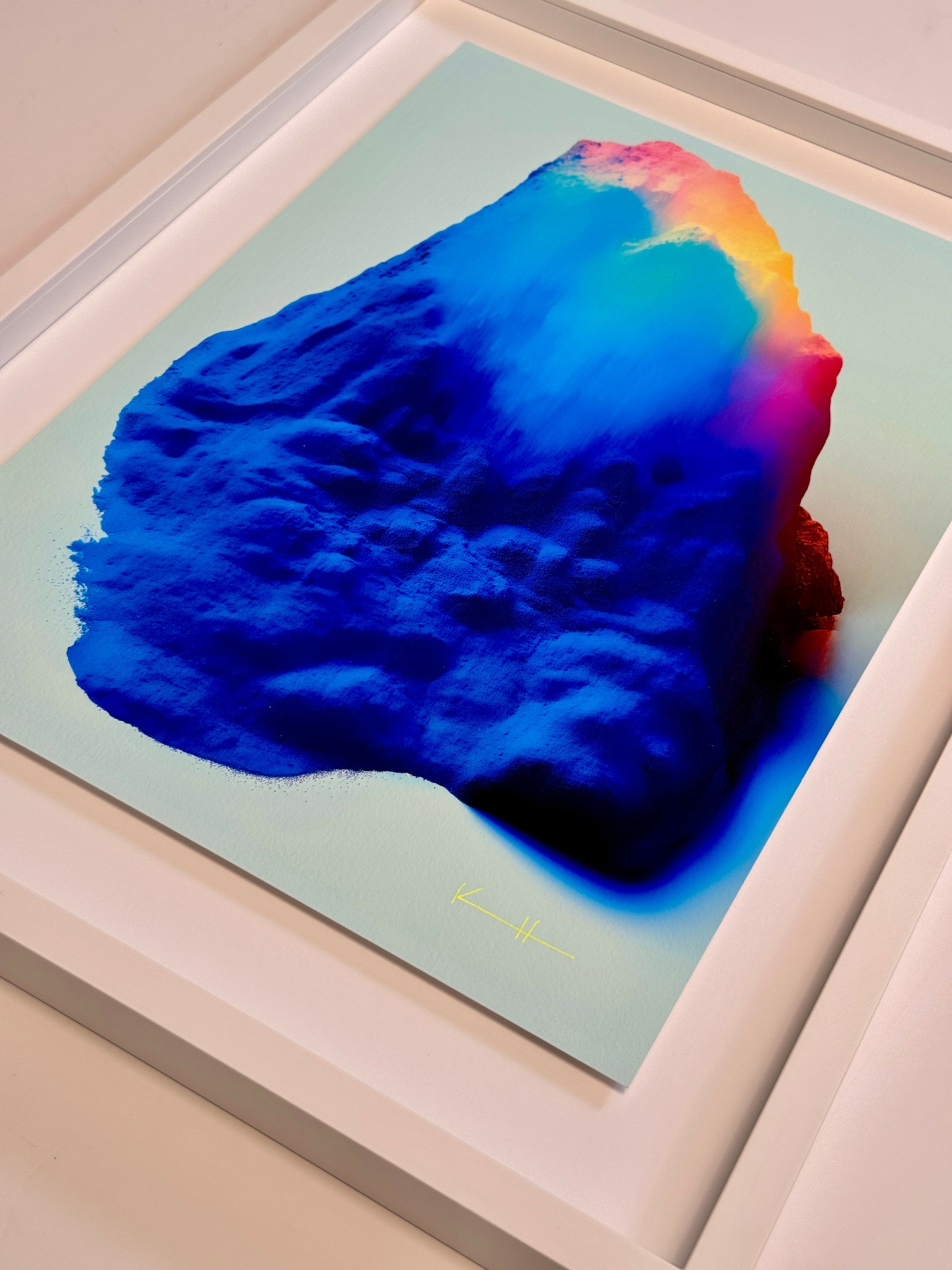 Colorful 3D textured artwork with blue, pink, yellow, and orange hues in a white frame.