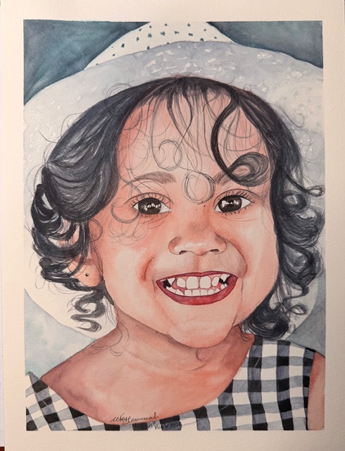 Child with curly hair smiling, wearing a checkered top, in front of a white hat and background.