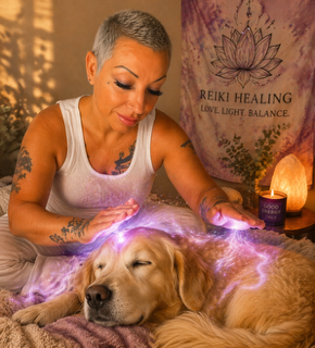Woman with short gray hair and tattoos gently places hands over a sleeping golden retriever, emitting purple light.