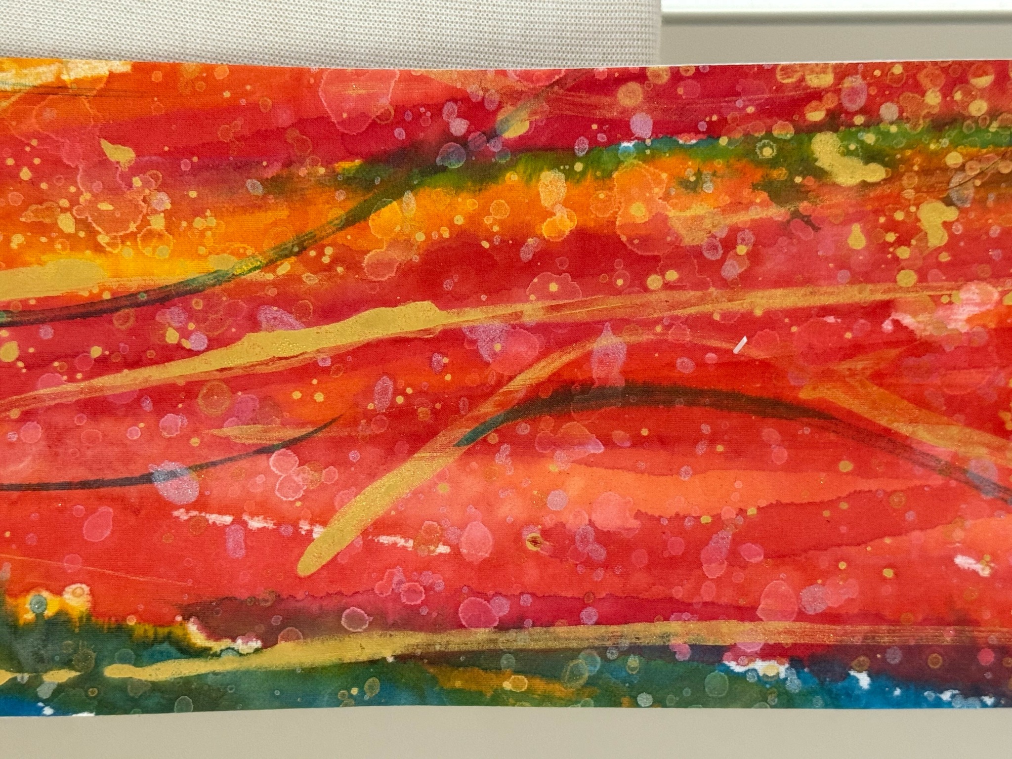 Abstract colorful painting with red, orange, yellow, green, and blue streaks and splatters.