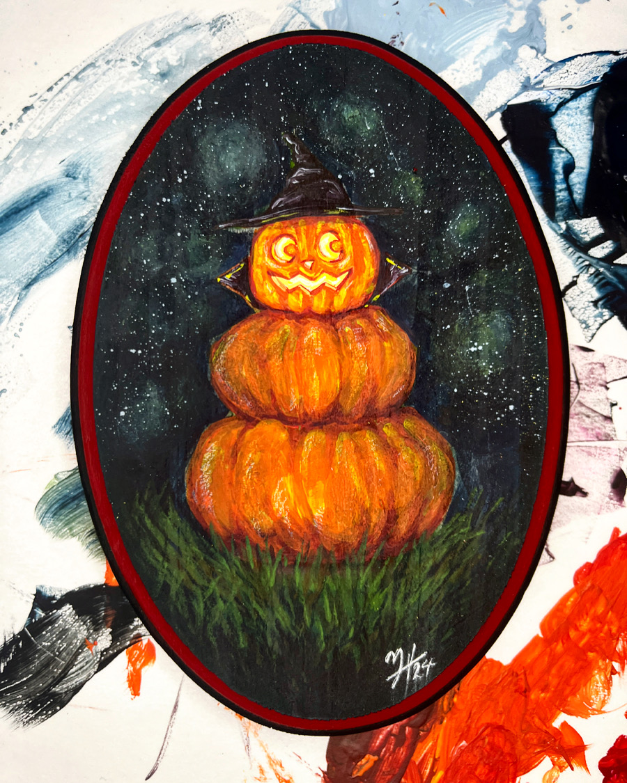 Pumpkin stack with a carved face, wearing a witch hat, set against a starry night background.