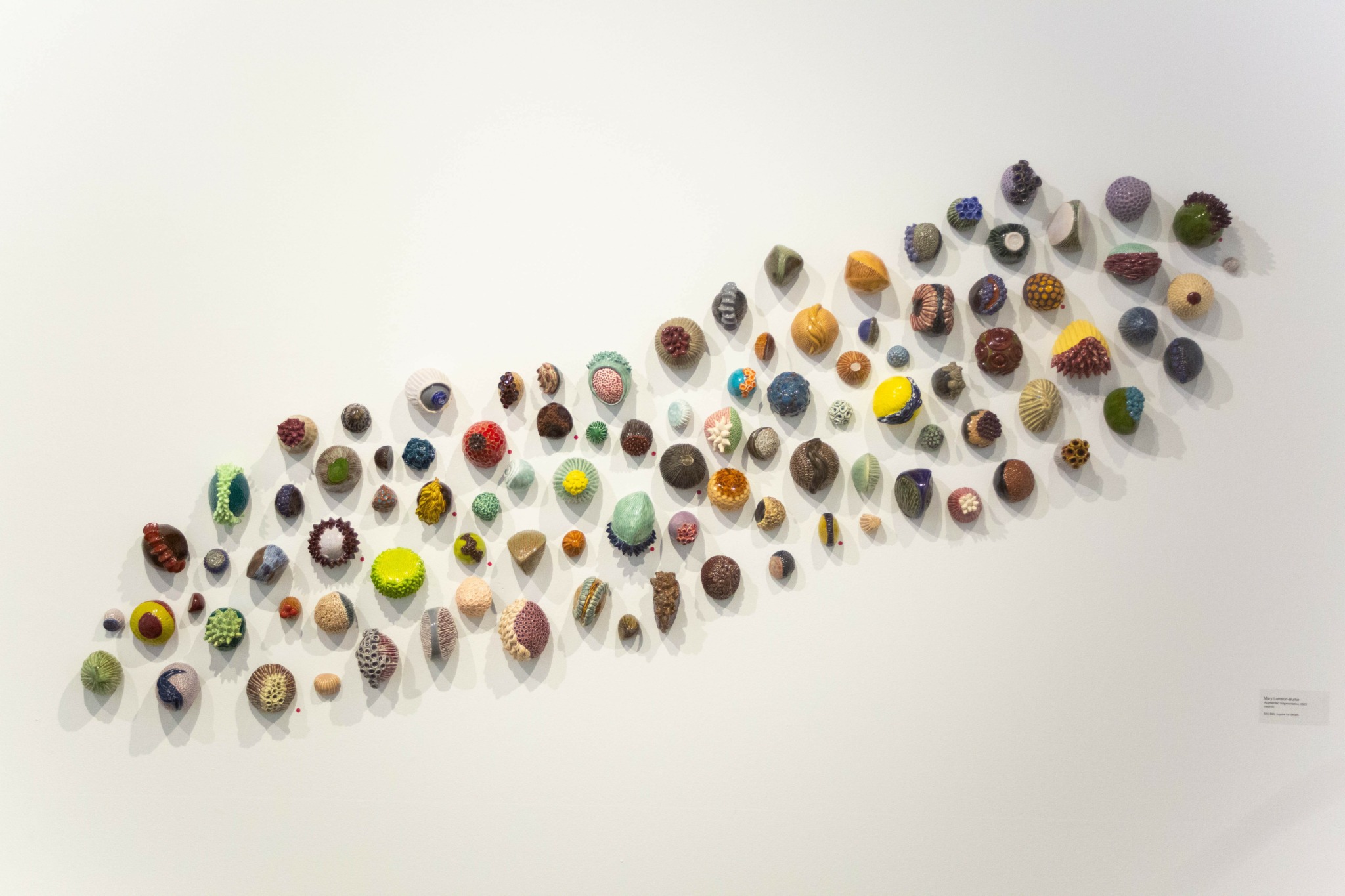 Various colorful small objects arranged in a diagonal pattern on a white background.