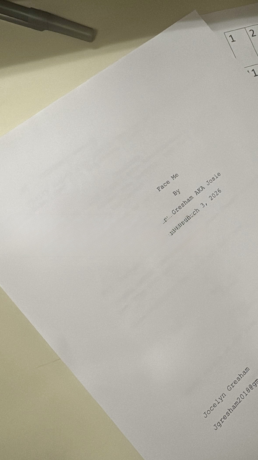Close-up of a white sheet of paper with printed text, partially visible on a light-colored surface.