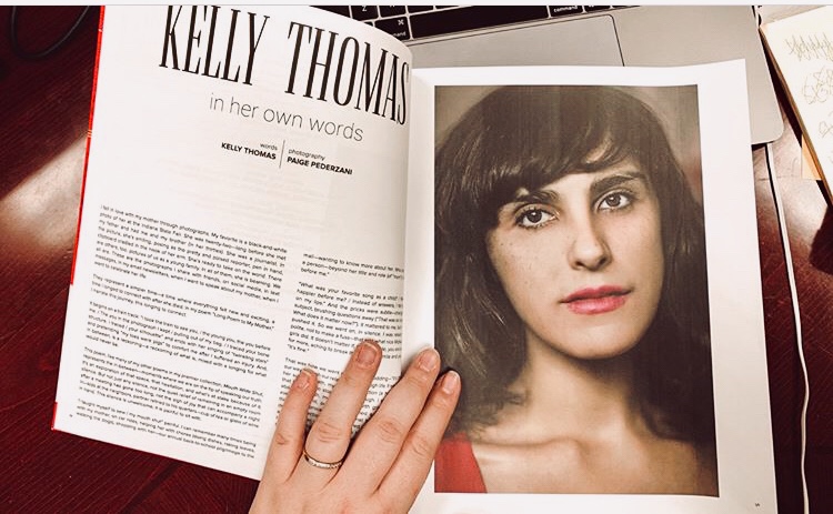 Open magazine with article about Kelly Thomas and a portrait of a woman with dark hair and bangs.