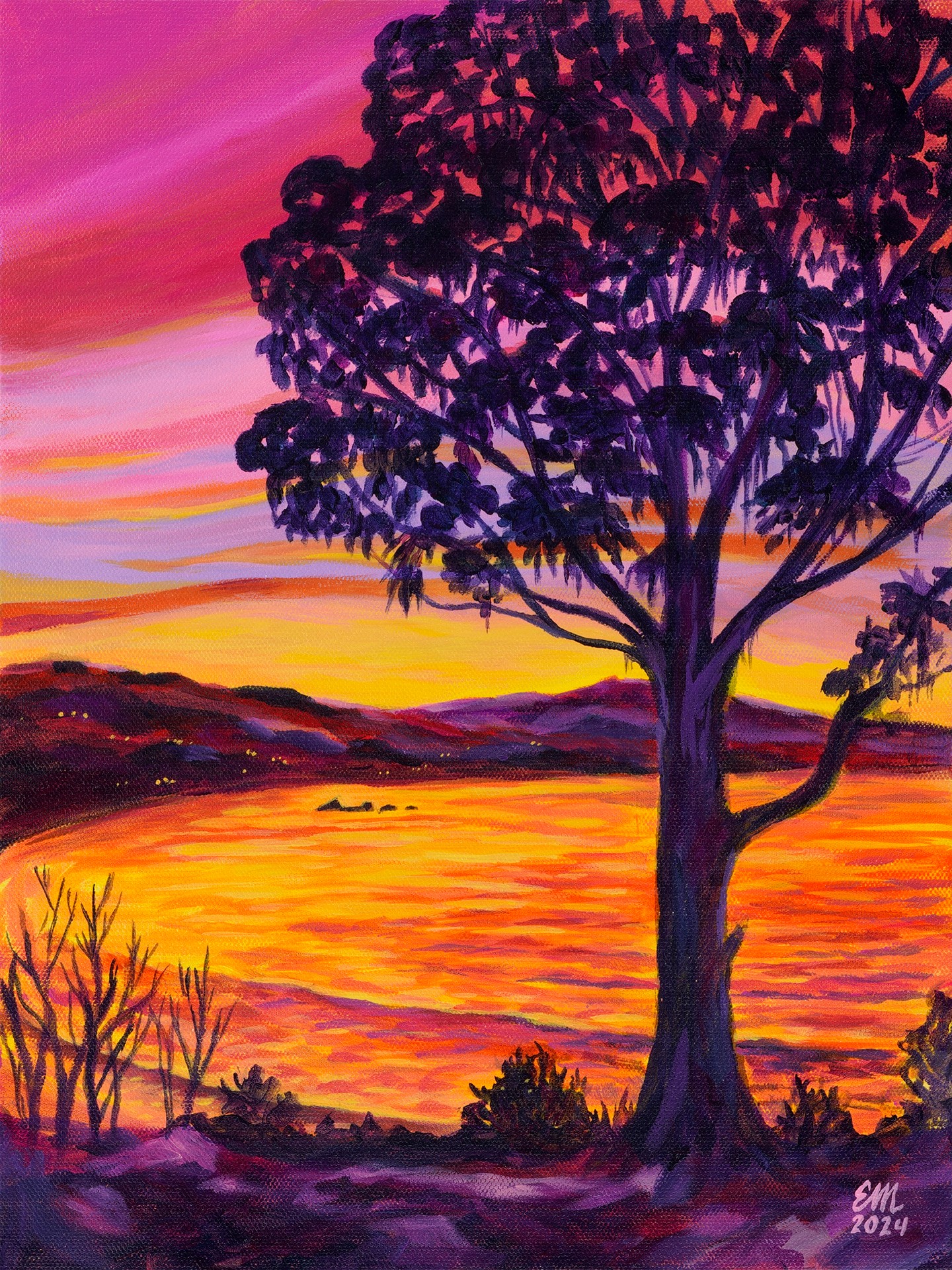 Tree with purple leaves beside a sunset over a body of water, colorful sky, and distant hills.