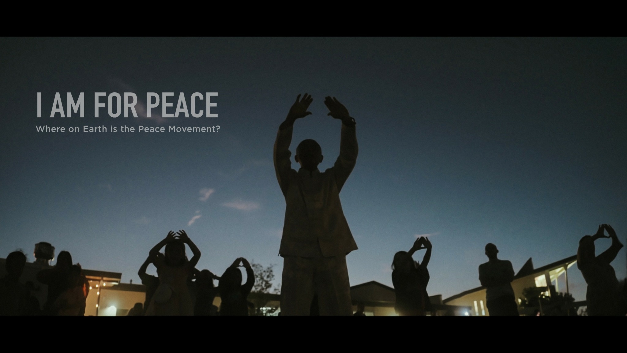 Group of people holding hands above heads during sunset, with text about peace and Earth movement.