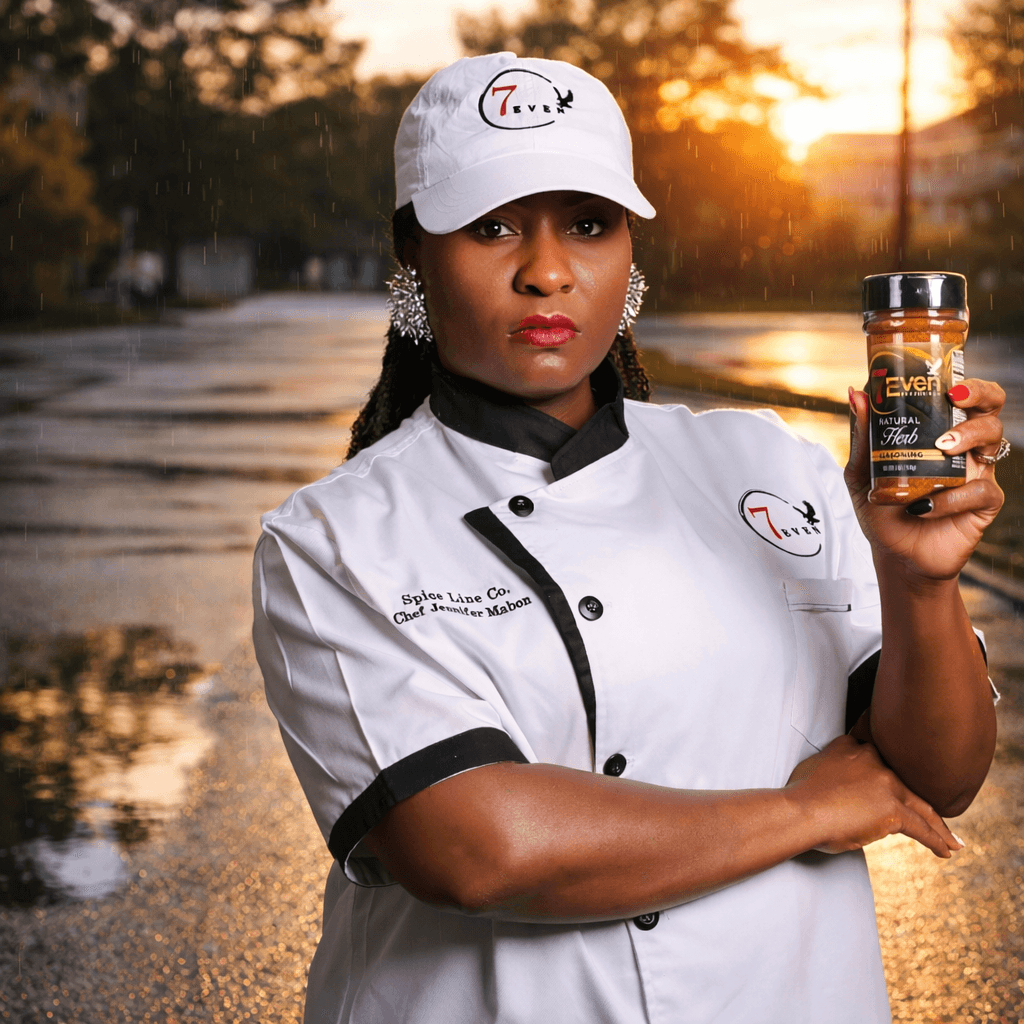 Woman in chef uniform holding supplement bottle outdoors during sunset, water and trees in background.