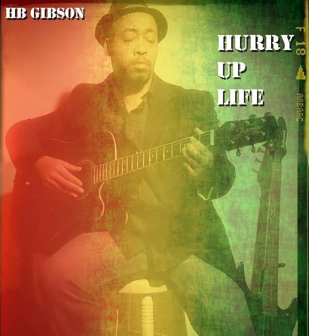 Person playing guitar with eyes closed, wearing a hat and scarf, sitting against a colorful background.