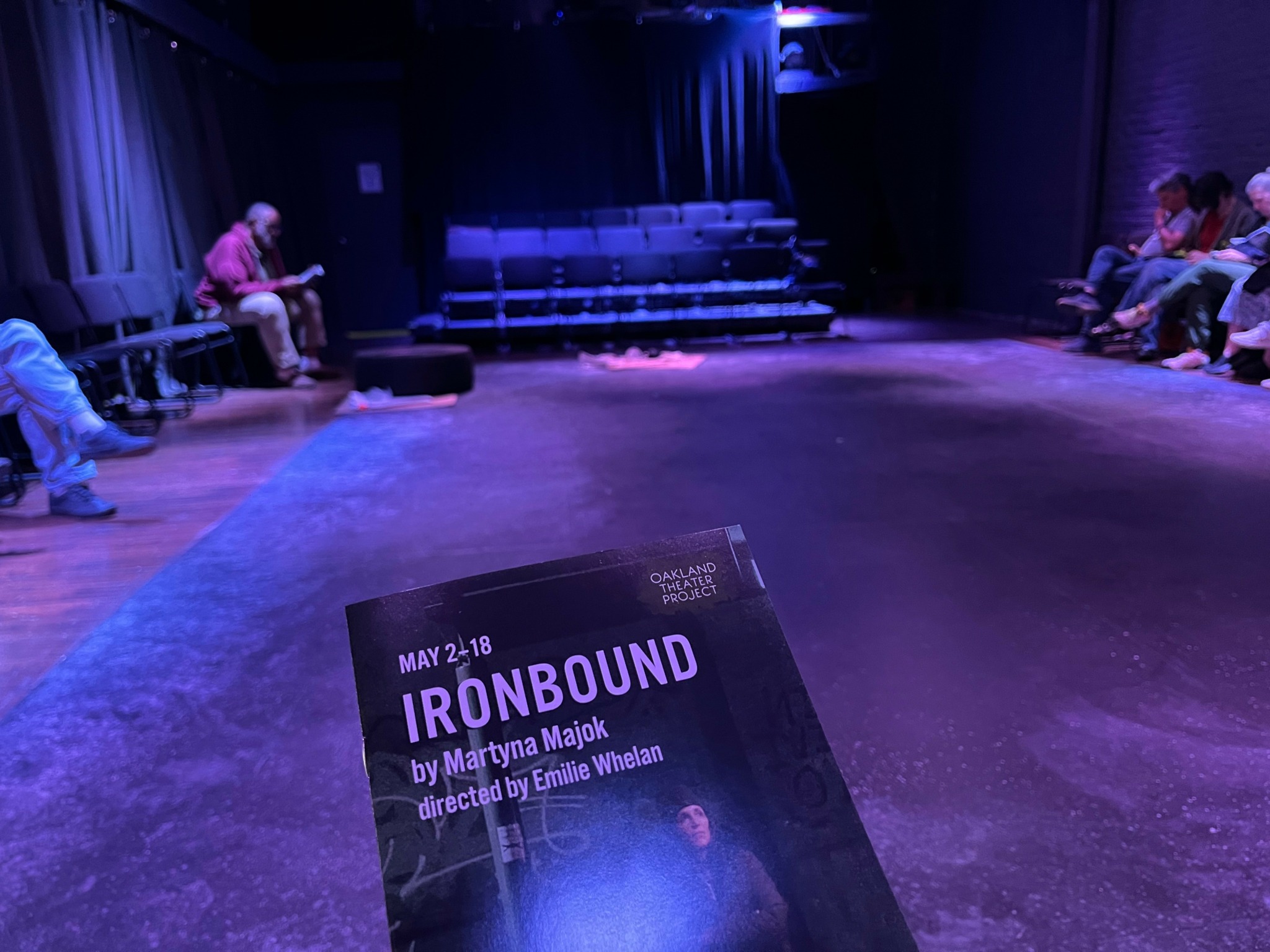 A flyer on the floor advertises a show called 'IRONBOUND' with details about dates, author, and director.