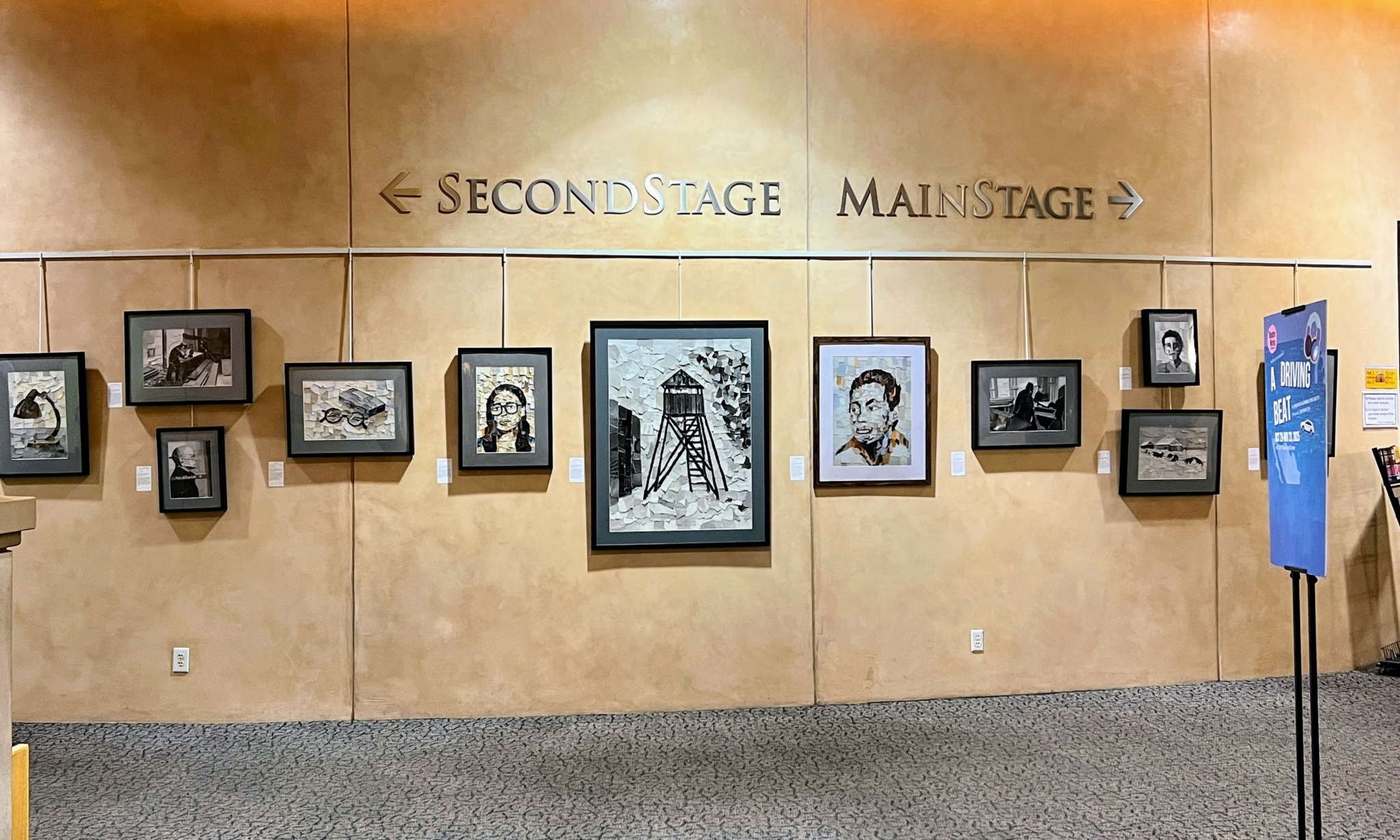 Gallery wall with framed photographs and artwork on a beige wall, labeled 'SECOND STAGE' and 'MAIN STAGE'.
