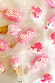 Pink and white Barbie-themed candies in clear plastic wrappers with ice cream cones and unicorn designs.