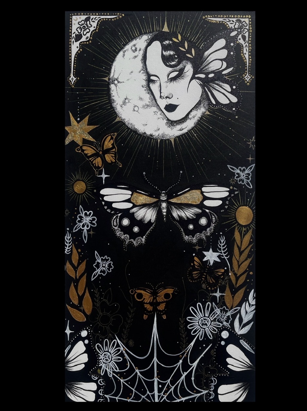 Artistic illustration featuring a woman's face, moon, butterflies, stars, flowers, and a spider web in black, white, and gold.