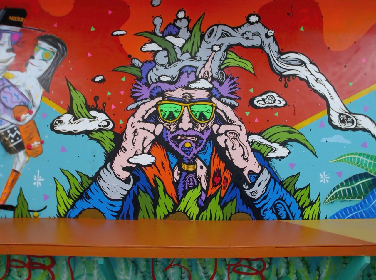 Colorful mural of a person with sunglasses, surrounded by plants and a rainbow, with a red background.