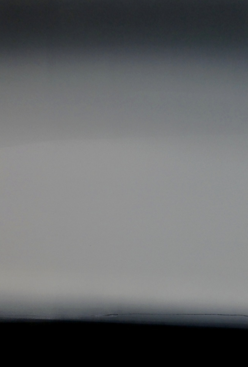 Blurred, gray gradient with darker top and lighter bottom.
