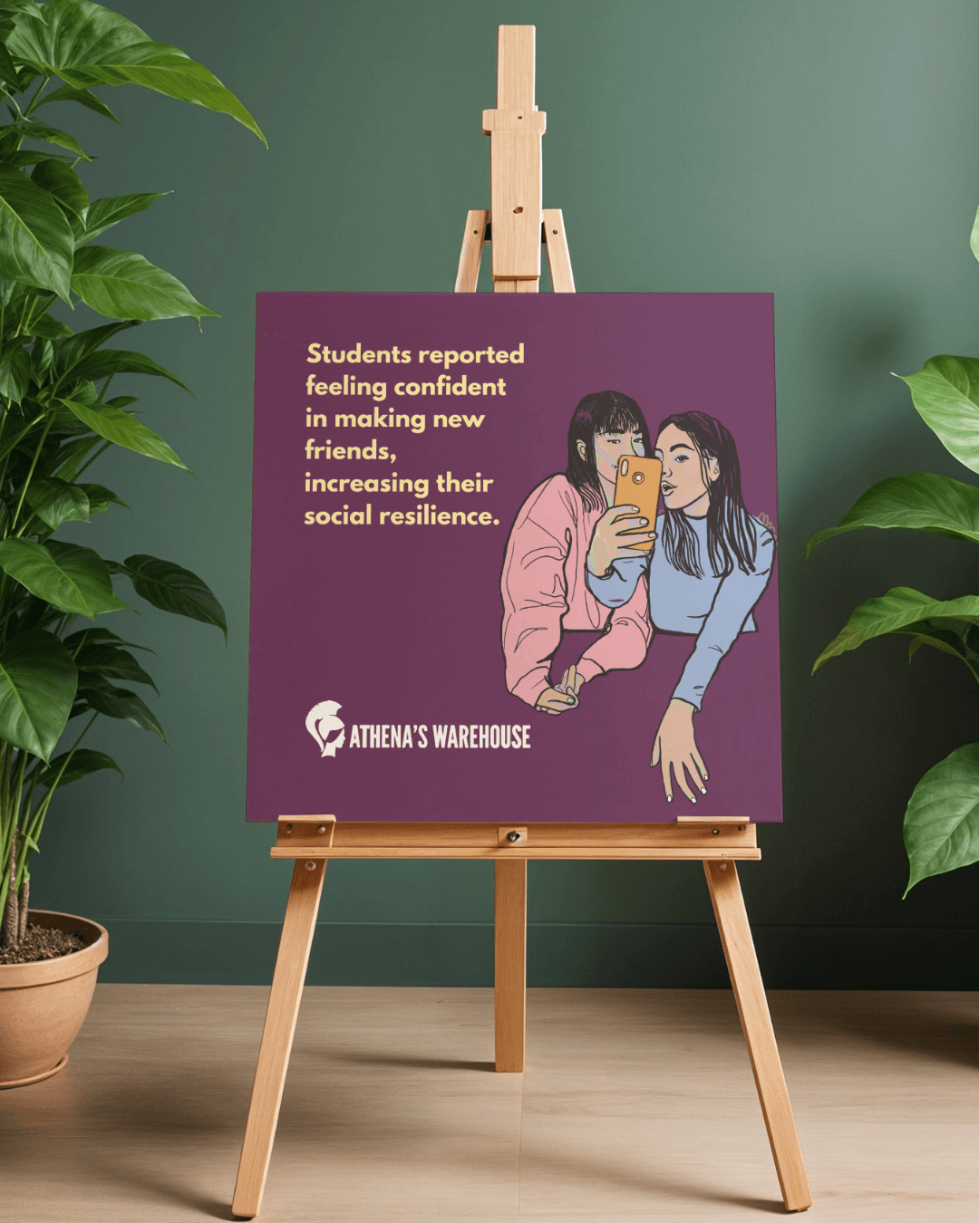 Purple poster on easel showing two girls taking a selfie, with text about student confidence and social resilience.