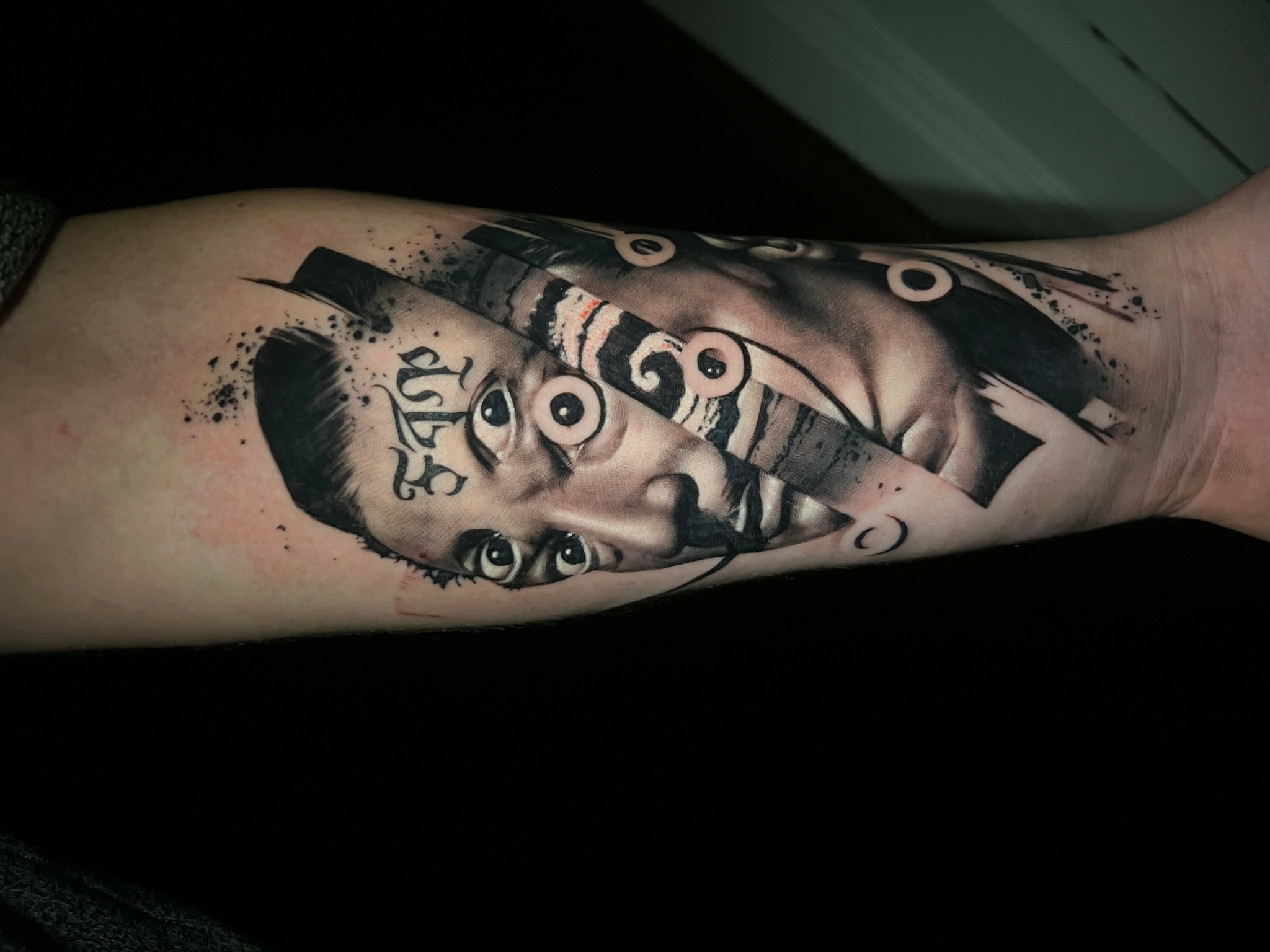 Tattoo of a woman's face with abstract elements and numbers on forearm.