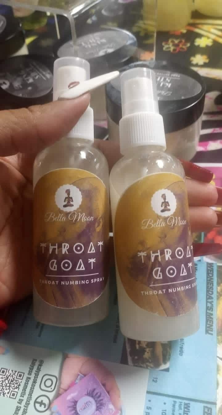 Two bottles with white spray caps held by a person's hand, labels with text and logo, background with various containers.