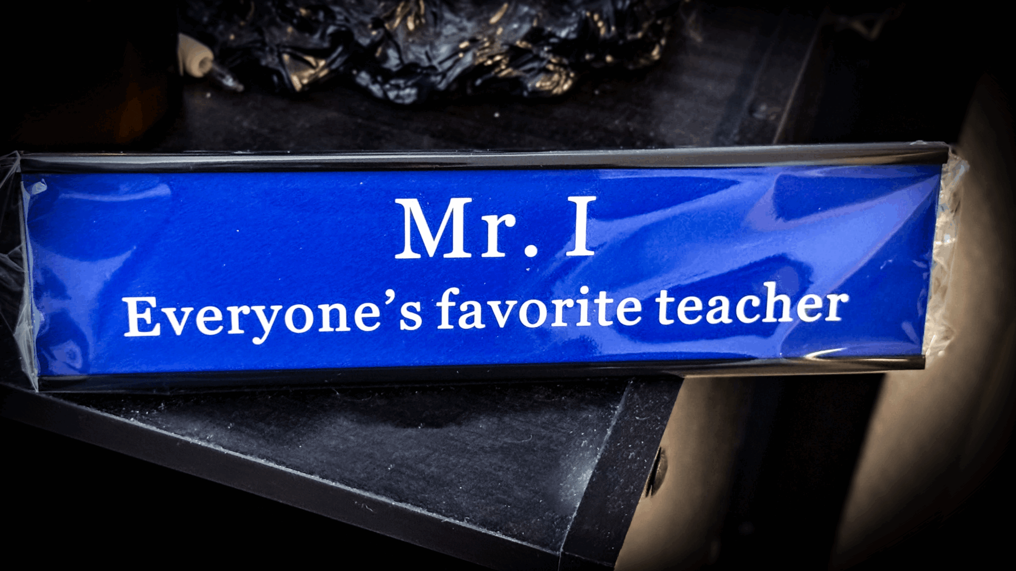 Blue rectangular box with white text reading 'Mr. I Everyone's favorite teacher'.